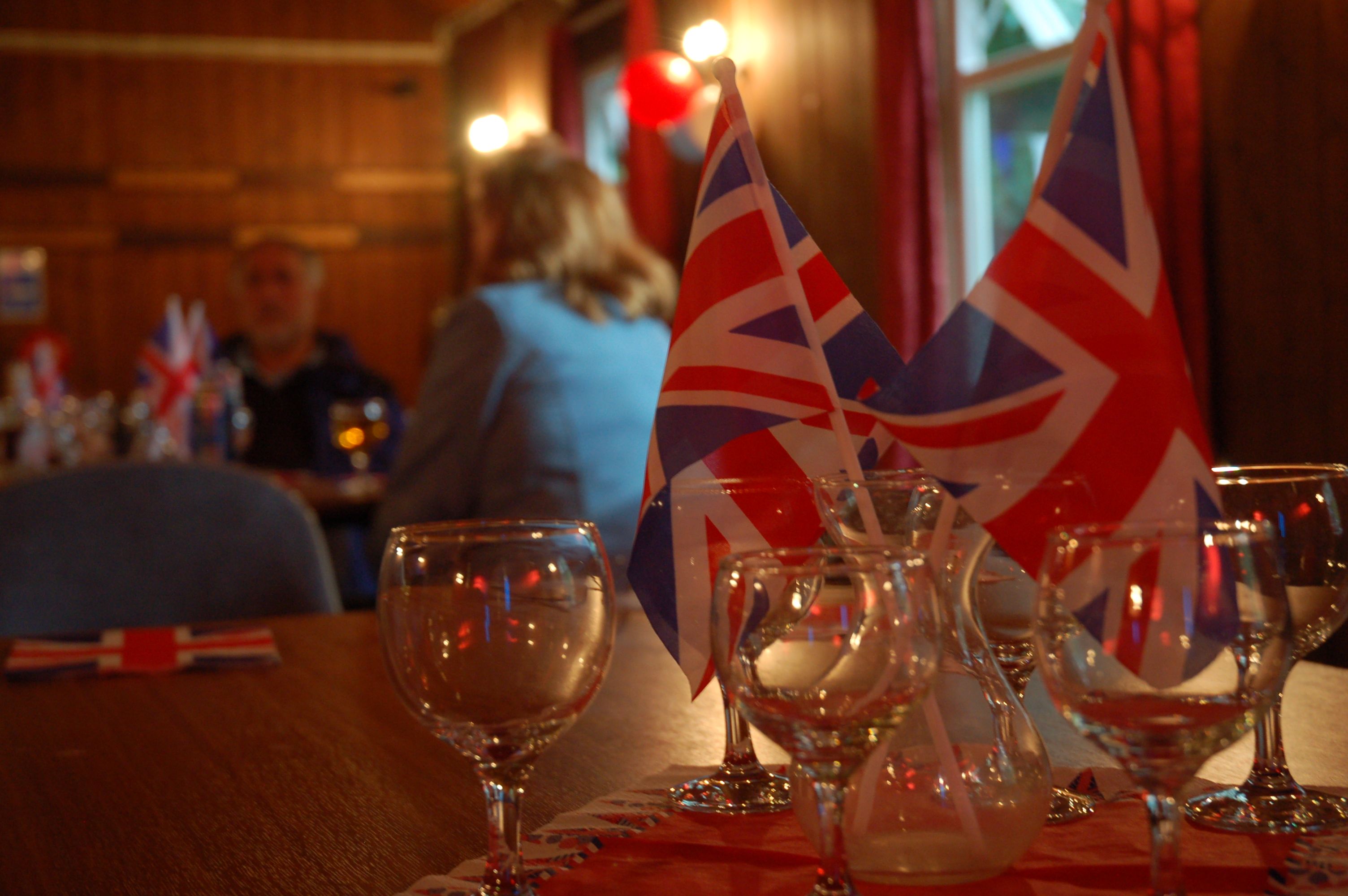 Defocused people behind CU flags on table